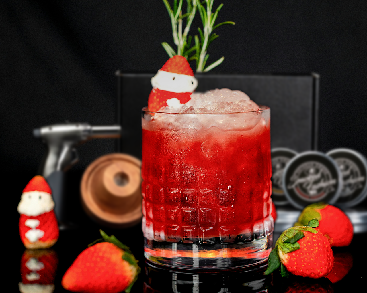 A smoked cocktail being prepared on a festive holiday table