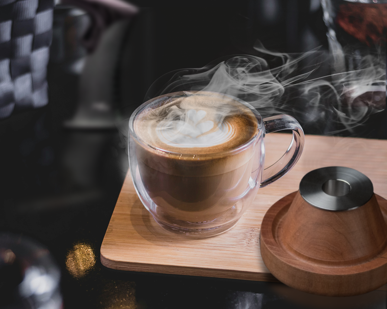 A steaming cup of smoked tea alongside a Smoked Fashioned kit